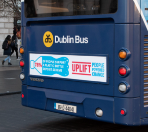 Photo of a Dublin bus with an Uplift banner saying that 78% of people support a plastic bottle deposit scheme