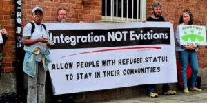 Campaigners holding a sign saying Integration not eviction